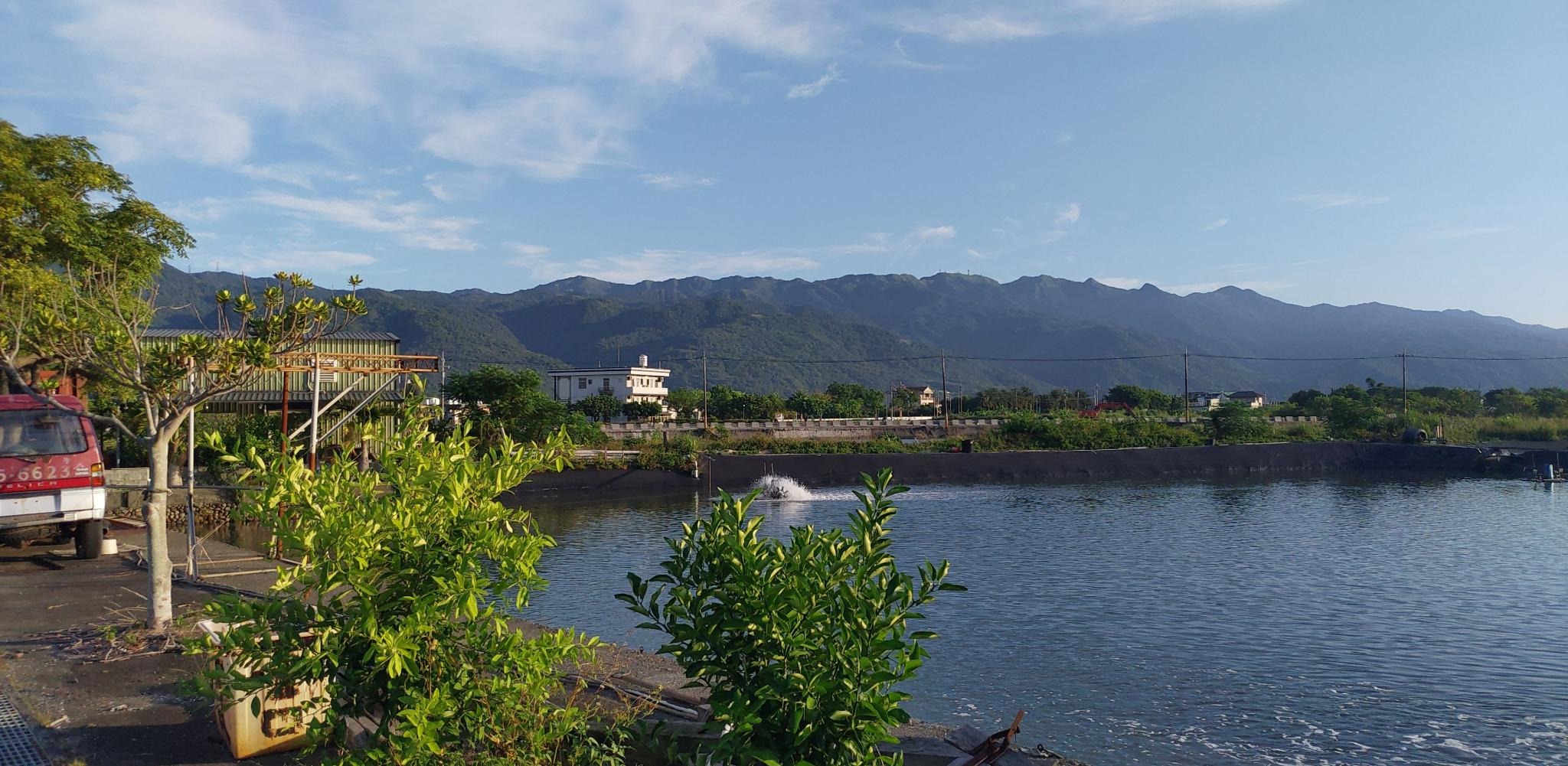 Landscape view from the Marine Research Station: fish pond in the foreground, green mountains in the background